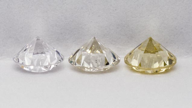 Suite of three diamond master stones; "E", "K-L" and "Z" in grading position: table down, pavilion view.