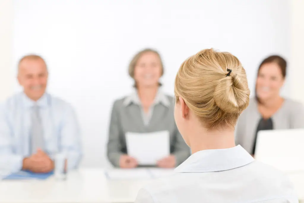 Job interview young woman with business team